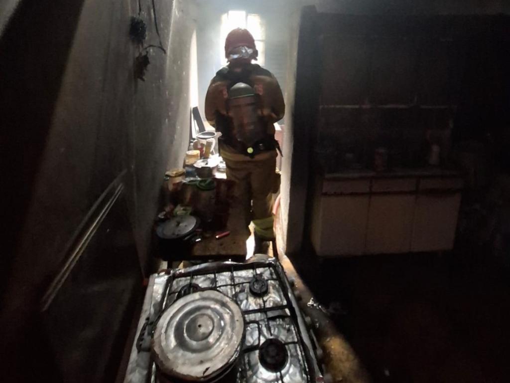 Bombeiro atua no rescaldo do local incendiado 