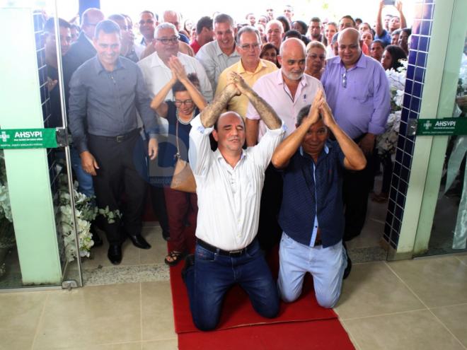 Prefeito Hamilton Rômulo e o vice, Geci Ribeiro, ajoelhados após a inauguração do hospital 